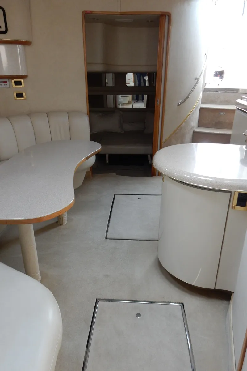 Slide: The Image of Interior of 1997 Sea Ray 450 yacht with modern seating and dining area. - 25