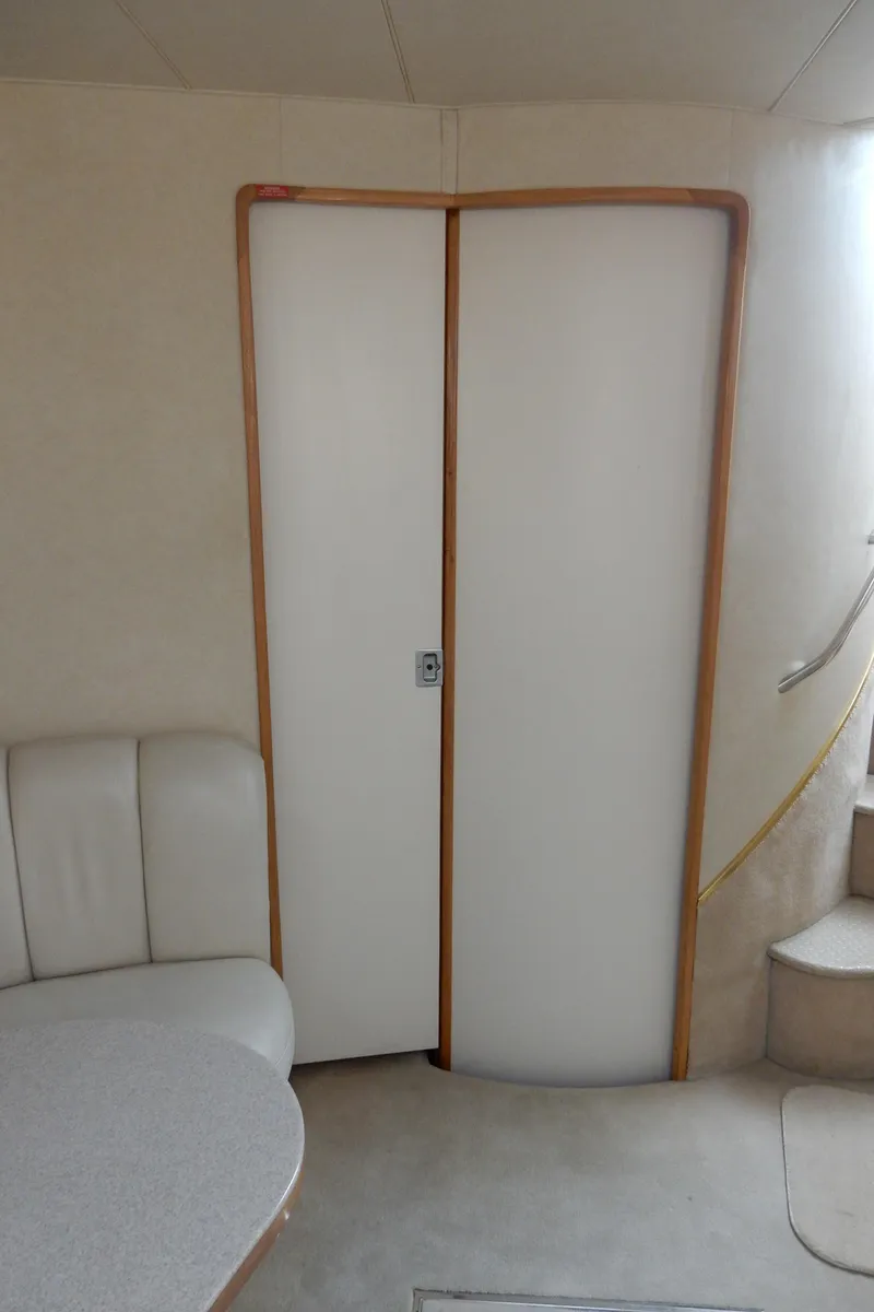 Slide: The Image of Interior of 1997 Sea Ray 450 yacht with white door and seating area. - 27