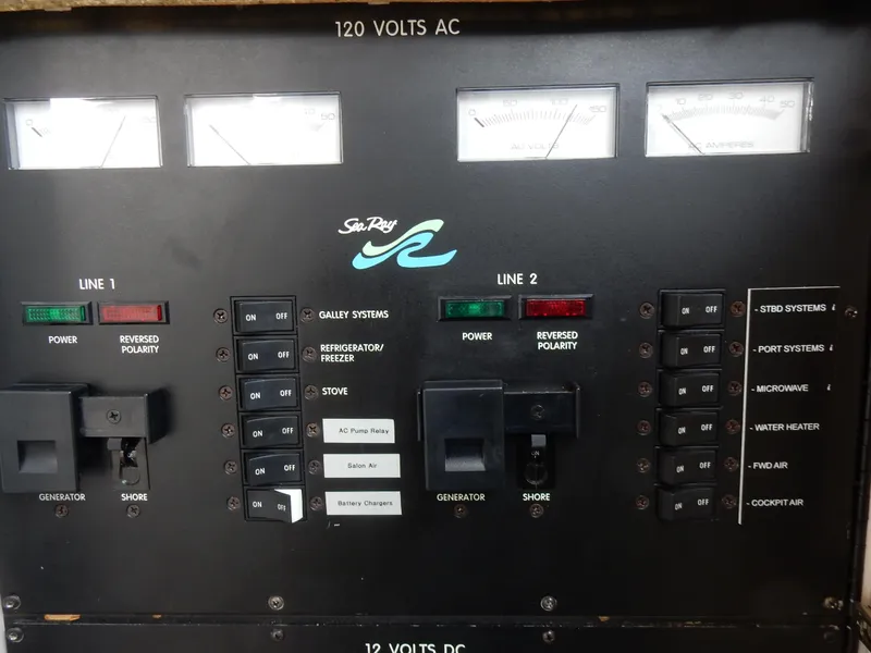 Slide: The Image of Electrical control panel of a 1997 Sea Ray 450 boat, featuring various switches and gauges. - 30