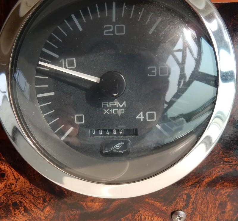 Slide: The Image of Close-up of 1997 Sea Ray 450 RPM gauge, showing 1048.9 RPM. - 33