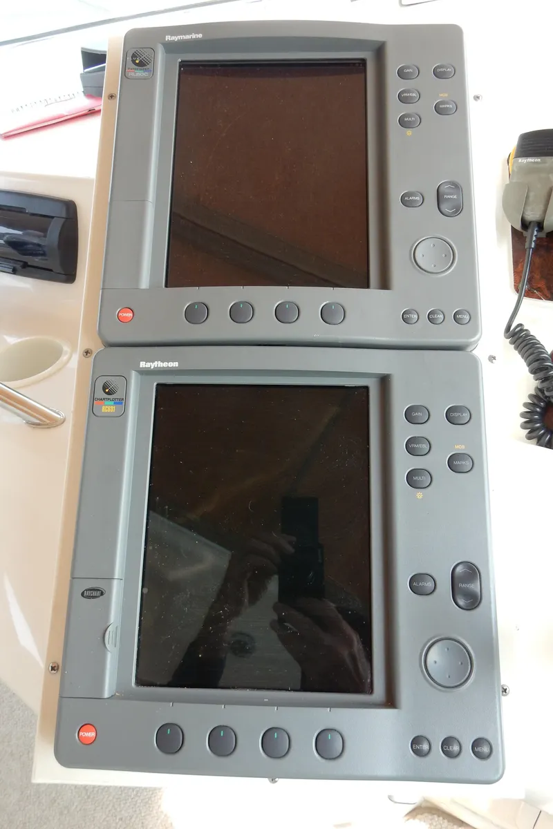 Slide: The Image of 1997 Sea Ray 450 navigation displays with control buttons and screens. - 35