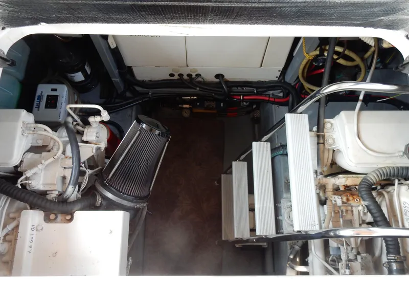 Slide: The Image of Engine compartment of a 1997 Sea Ray 450, showcasing mechanical components and wiring. - 42