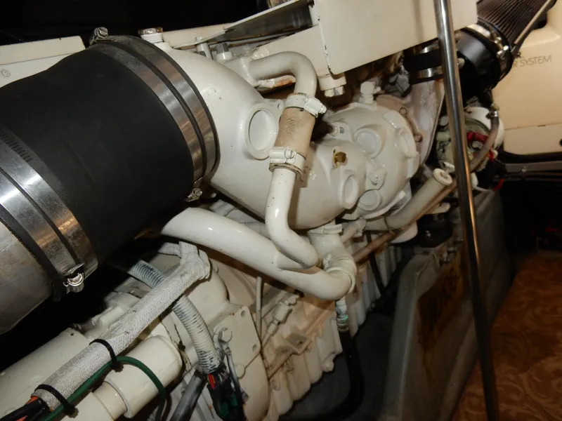 Slide: The Image of Engine components of a 1997 Sea Ray 450 boat, showcasing intricate piping and mechanical details. - 48