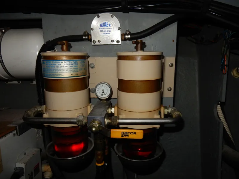 Slide: The Image of Engine room components of a 1997 Sea Ray 450, featuring dual fuel filters. - 49