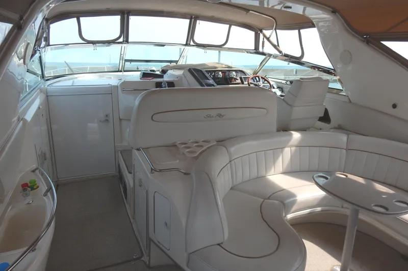 Slide: The Image of 1997 Sea Ray 450 yacht interior with white seating and helm, showcasing luxury design. - 6