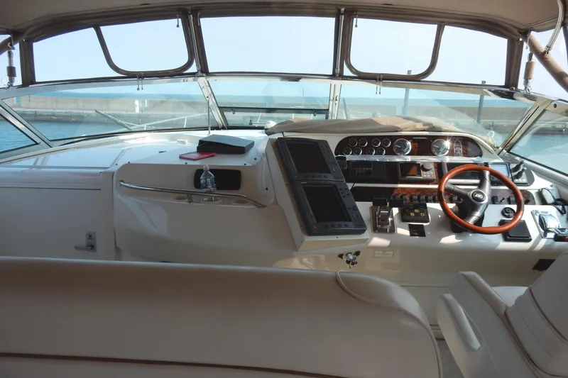 Slide: The Image of 1997 Sea Ray 450 yacht helm with steering wheel and control panels. - 7