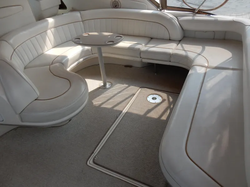 Slide: The Image of 1997 Sea Ray 450 yacht interior with beige seating and small table. - 8