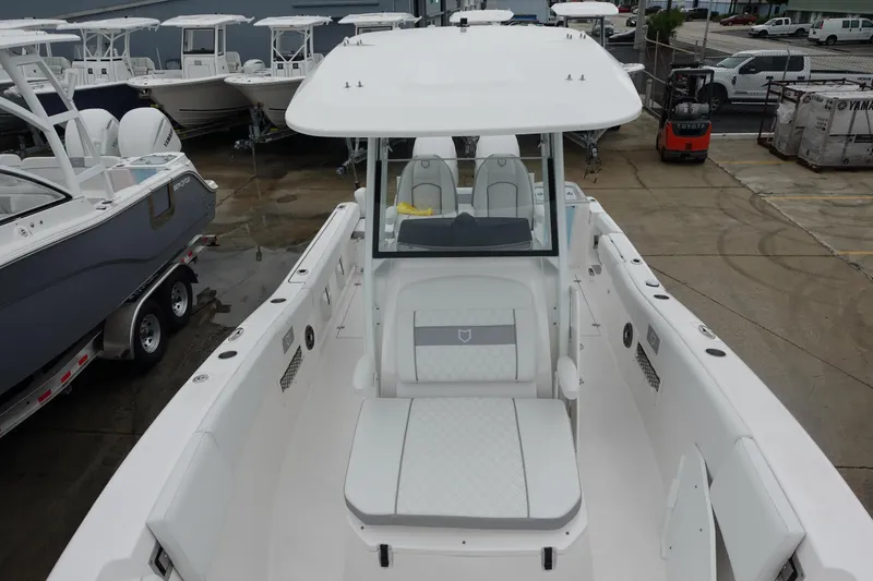 Slide: The Image of 2025 Sea Fox 268 Commander boat, white interior, docked with other boats in the background. - 19