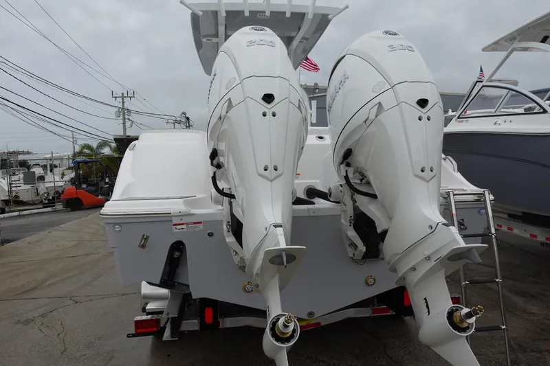 Slide: The Image of 2025 Sea Fox 268 Commander boat with dual outboard engines, docked at a marina. - 30