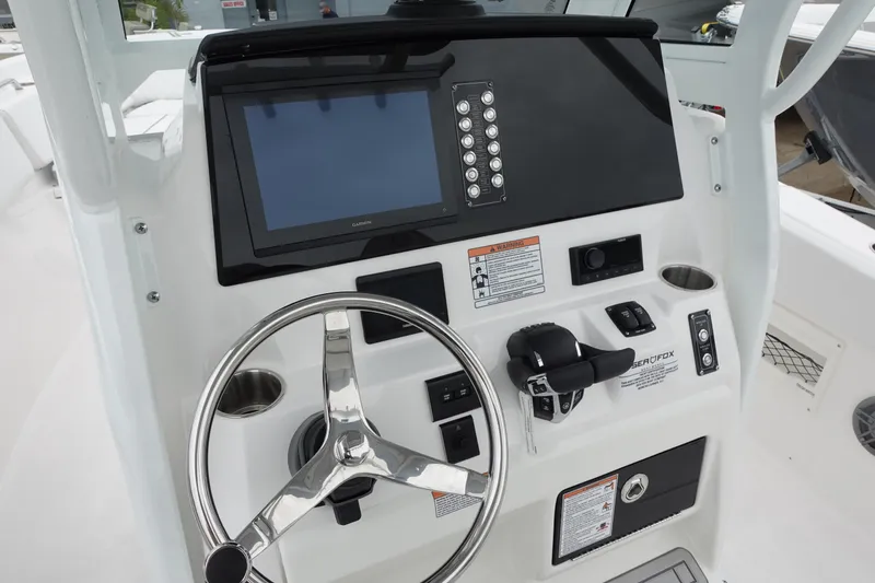 Slide: The Image of 2025 Sea Fox 268 Commander dashboard with steering wheel and electronic controls. - 4