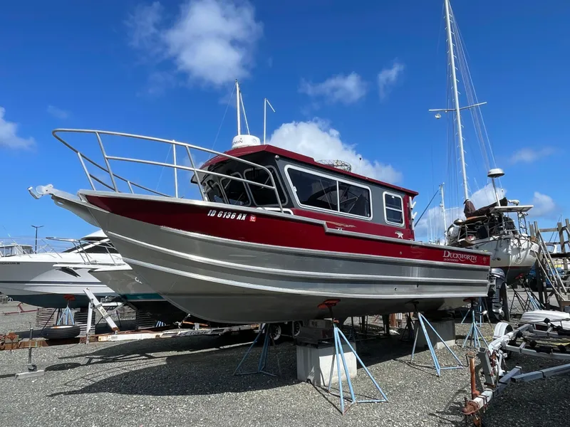 Slide: The Image of 2018 Duckworth 28 Offshore boat on dry dock under a clear blue sky. - 29
