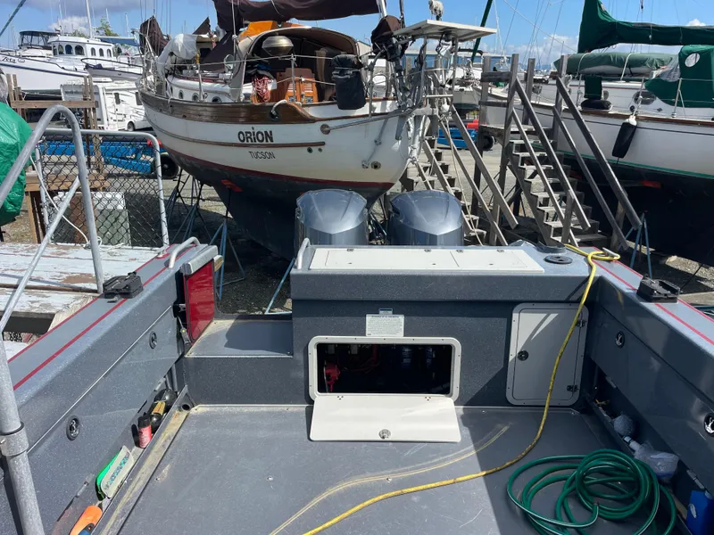 Slide: The Image of 2018 Duckworth 28 Offshore boat interior with equipment and docked sailboats in background. - 34