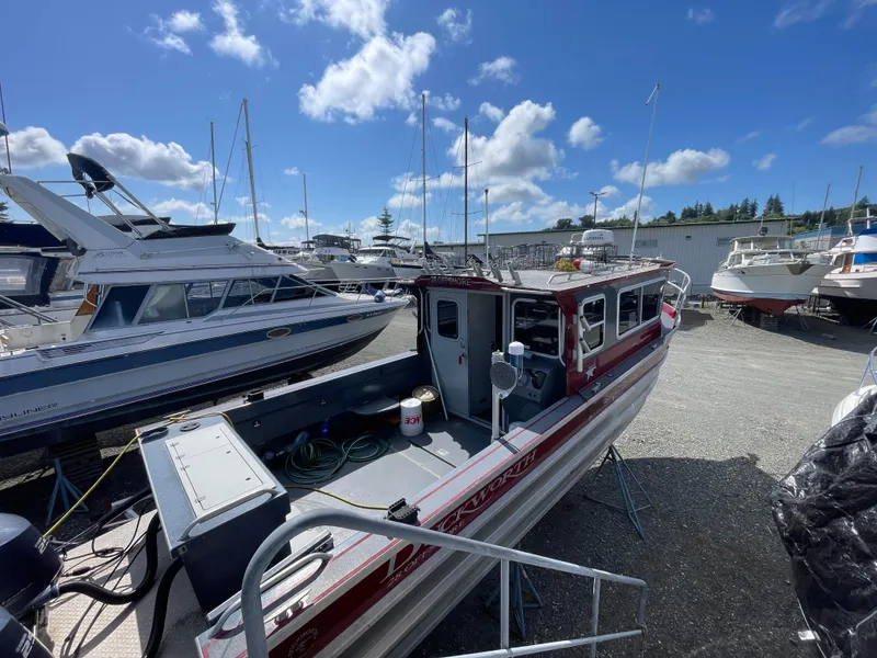 Slide: The Image of 2018 Duckworth 28 Offshore boat in marina, surrounded by other vessels under a clear blue sky. - 35