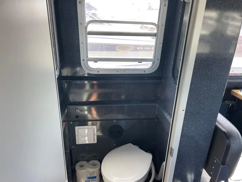 Slide: The Image of 2018 Duckworth 28 Offshore boat interior with compact bathroom and window. - 37