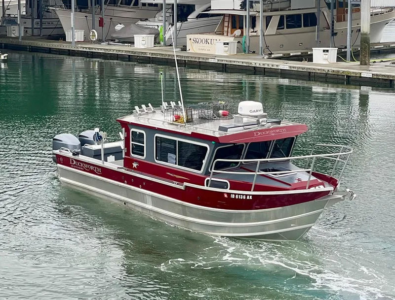 Slide: The Image of 2018 Duckworth 28 Offshore boat in marina, red and silver design, calm water. - 4