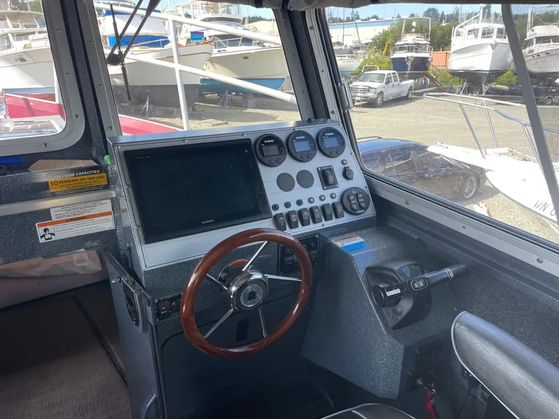 Slide: The Image of Interior view of 2018 Duckworth 28 Offshore boat cockpit with steering wheel and control panel. - 43