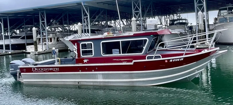 Slide: The Image of 2018 Duckworth 28 Offshore boat docked in marina, featuring sleek red and silver design. - 6