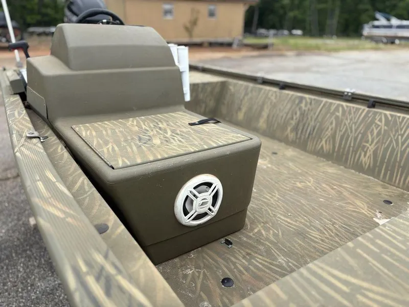 Slide: The Image of 2020 Tracker GRIZZLY® 1648 SC boat interior with camo design and speaker detail. - 14