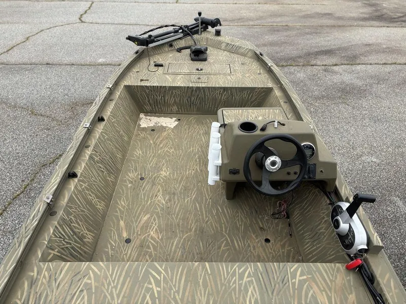 Slide: The Image of 2020 Tracker GRIZZLY® 1648 SC boat interior with camouflage design and steering console. - 3