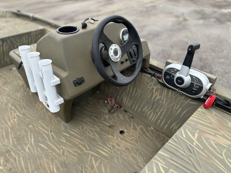 Slide: The Image of 2020 Tracker GRIZZLY® 1648 SC boat console with steering wheel and controls. - 4