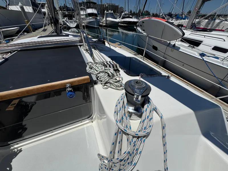 Slide: The Image of Sailboat deck of 1992 Hunter Legend 375, featuring winch and ropes in marina setting. - 13