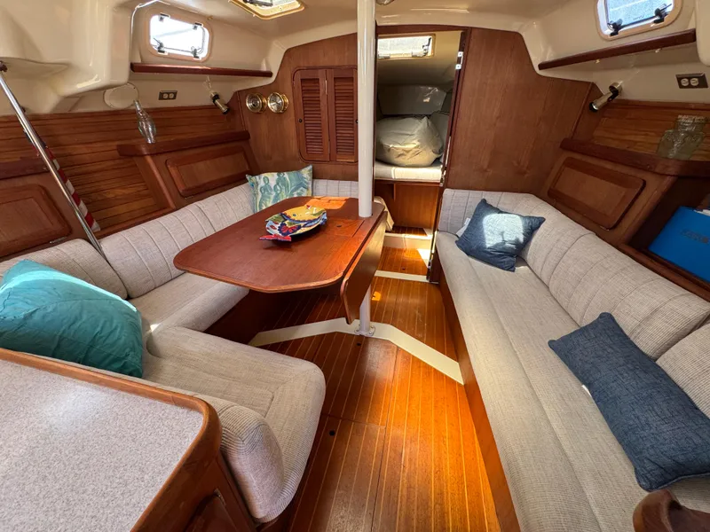 Slide: The Image of Cozy interior of 1992 Hunter Legend 375 sailboat with wooden finishes and cushioned seating. - 15