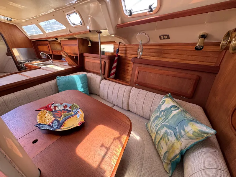 Slide: The Image of Cozy interior of 1992 Hunter Legend 375 sailboat with dining area and colorful decor. - 17