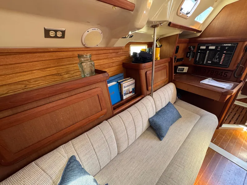 Slide: The Image of Interior of 1992 Hunter Legend 375 sailboat with wood paneling and cozy seating area. - 19