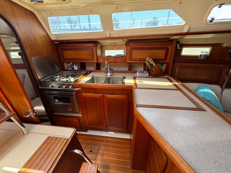 Slide: The Image of Interior of 1992 Hunter Legend 375 sailboat with wooden cabinetry and kitchen amenities. - 22