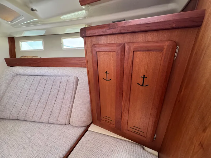 Slide: The Image of Interior of 1992 Hunter Legend 375 sailboat with wooden cabinet and cushioned seating. - 26