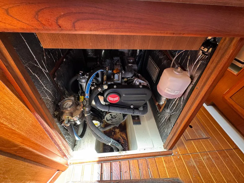 Slide: The Image of Engine compartment of a 1992 Hunter Legend 375 sailboat, showcasing mechanical components. - 28