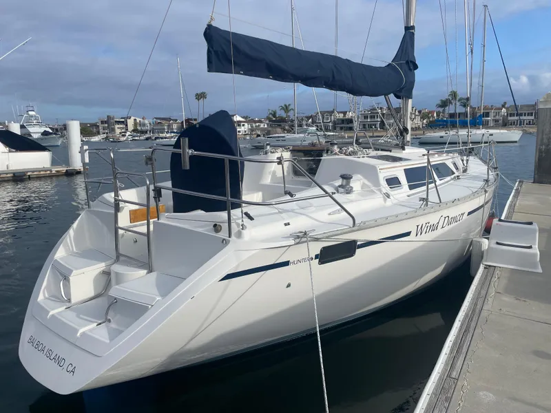 Slide: The Image of 1992 Hunter Legend 375 sailboat docked at marina, featuring sleek design and spacious deck. - 3