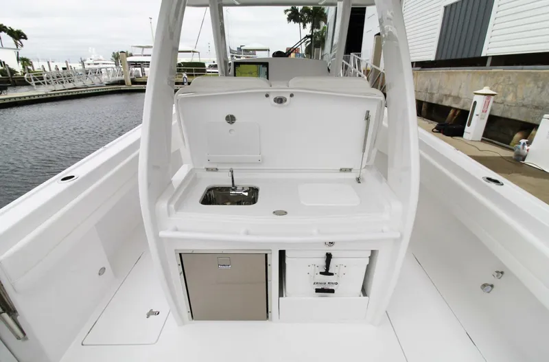 Slide: The Image of 2024 Intrepid 375 Nomad SE boat interior with sink and storage compartments. - 10