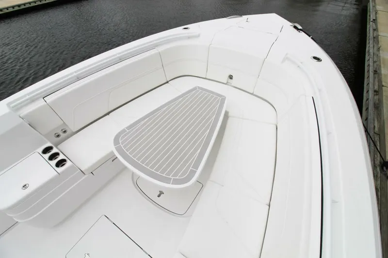 Slide: The Image of 2024 Intrepid 375 Nomad SE boat interior with sleek seating and table design. - 14