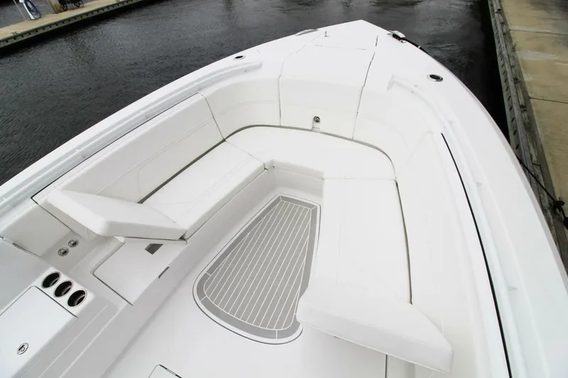 Slide: The Image of 2024 Intrepid 375 Nomad SE boat with spacious white seating area. - 16