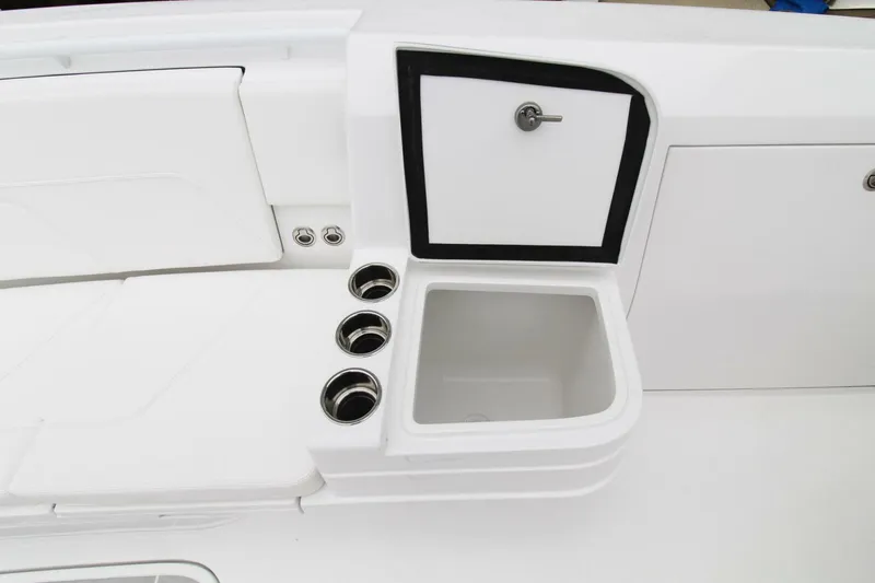 Slide: The Image of 2024 Intrepid 375 Nomad SE boat interior with sink and storage compartments. - 18