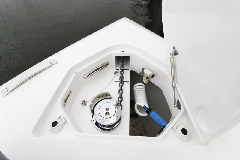 Slide: The Image of Anchor compartment of 2024 Intrepid 375 Nomad SE boat, featuring chain and hose storage. - 21