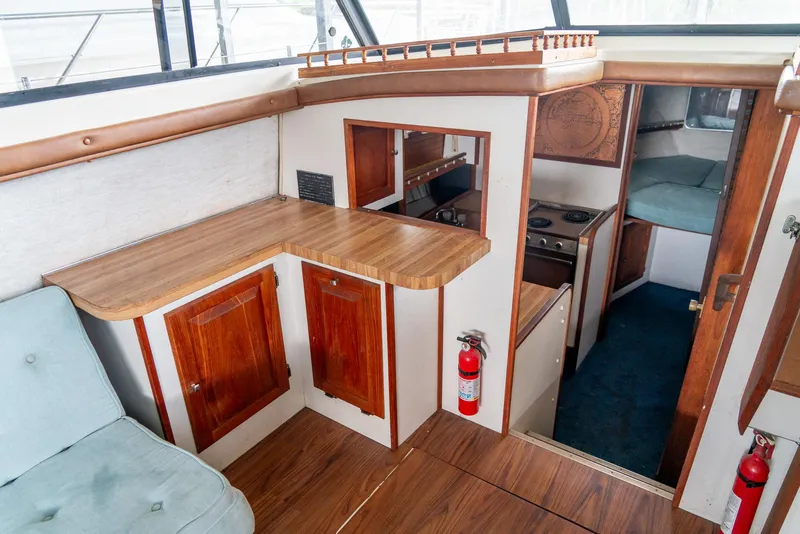 Slide: The Image of Interior of a 1979 Mainship 34 boat with wood cabinetry and compact kitchen area. - 21