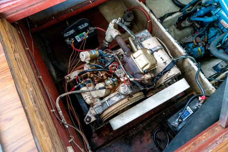 Slide: The Image of 1979 Mainship 34 engine compartment with visible wiring and components. - 31