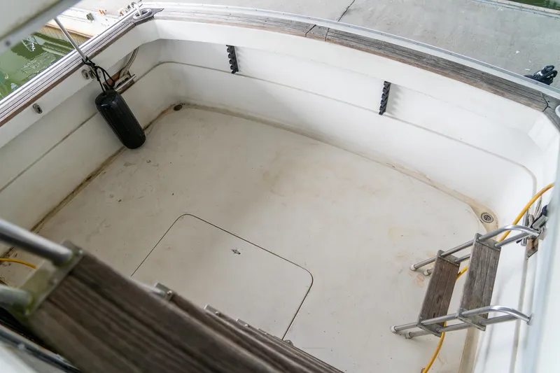 Slide: The Image of 1979 Mainship 34 boat deck with ladder and railing, featuring a clean, spacious layout. - 8