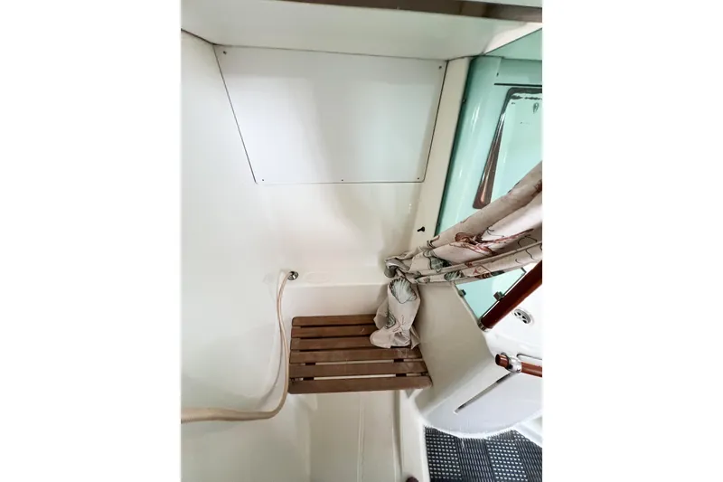 Slide: The Image of Interior of 2002 Beneteau 361 sailboat with wooden seat and nautical decor. - 10
