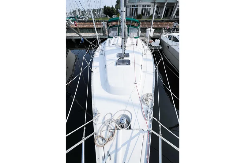 Slide: The Image of 2002 Beneteau 361 sailboat docked, showcasing deck and rigging details. - 2