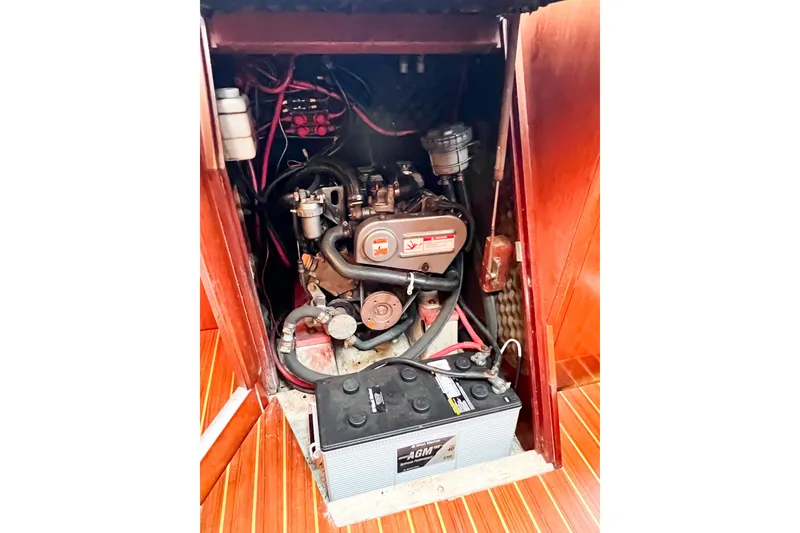 Slide: The Image of Engine compartment of a 2002 Beneteau 361 sailboat, featuring battery and wiring. - 33
