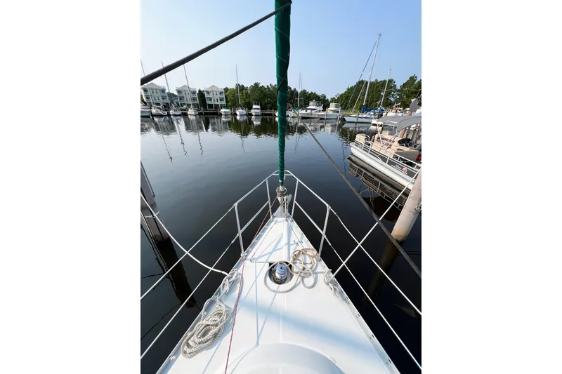 Slide: The Image of Bow view of a 2002 Beneteau 361 sailboat docked in a marina. - 4