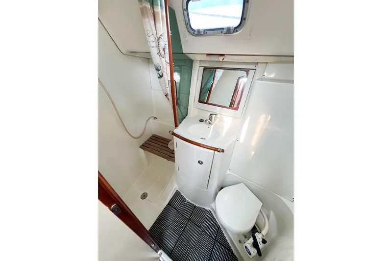 Slide: The Image of Bathroom of 2002 Beneteau 361 yacht with sink, toilet, and shower area. - 8