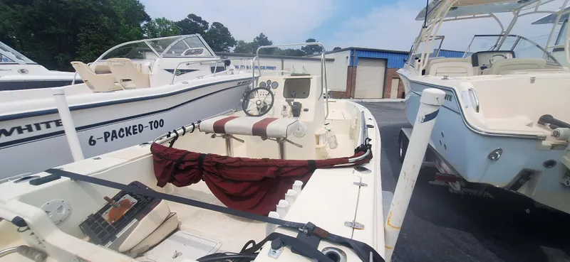 The Image of 1994 Scout 1720 CC Sportfish boat docked among other vessels. - 1