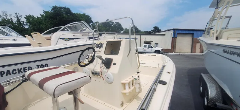 Slide: The Image of 1994 Scout 1720 CC Sportfish boat with steering wheel, parked outdoors. - 2
