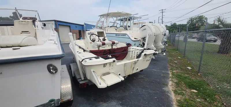 Slide: The Image of 1994 Scout 1720 CC Sportfish boat on trailer, parked outdoors near other boats. - 5