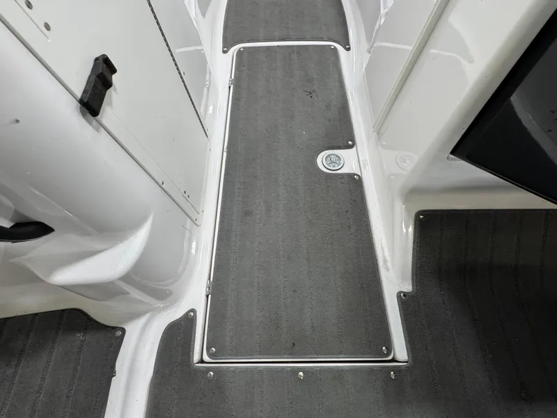 Slide: The Image of Yamaha Boats 212X 2014 interior flooring with gray carpet and white trim. - 10