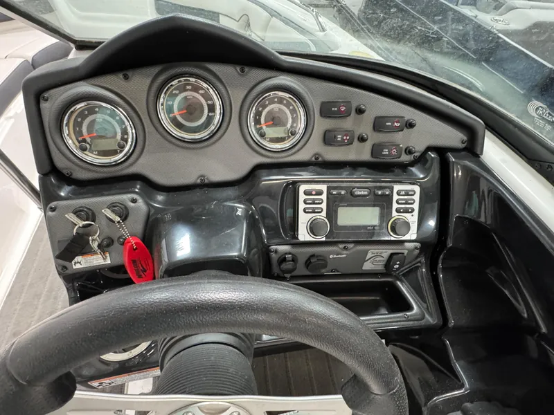 Slide: The Image of Dashboard of a 2014 Yamaha Boats 212X, featuring gauges and controls. - 11